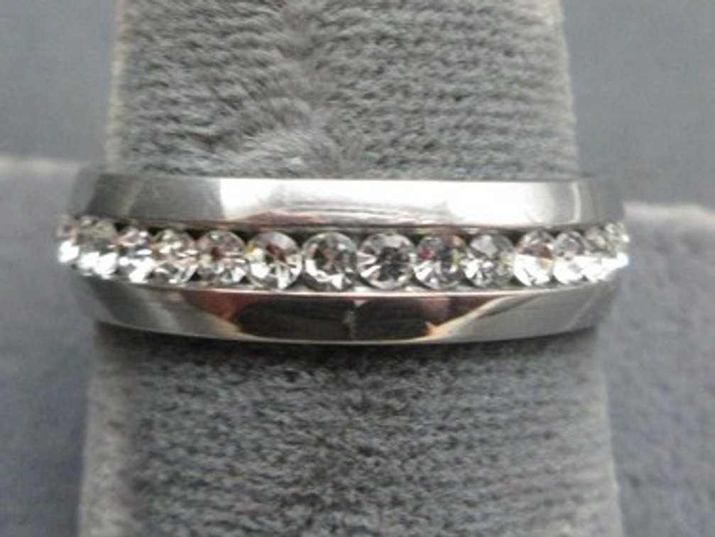 Unmarked silver-tone wedding band with clear stones