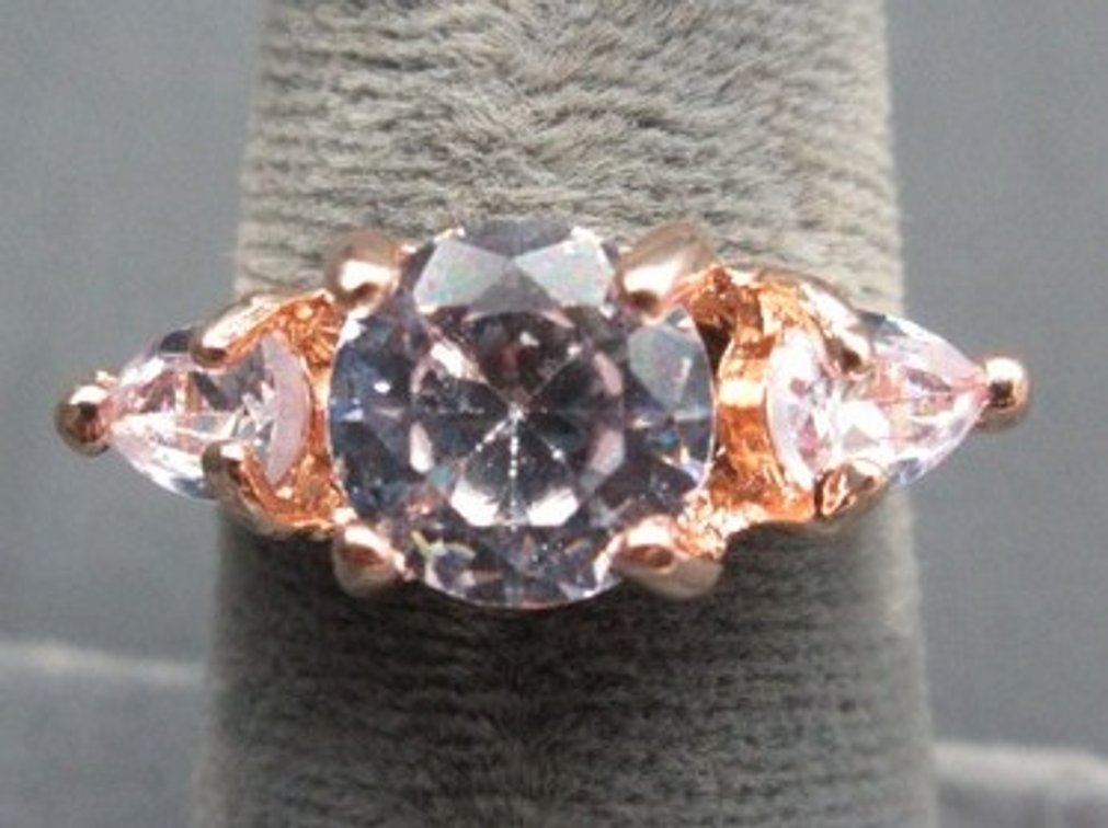 Unmarked rose-gold-colored ring with clear stones