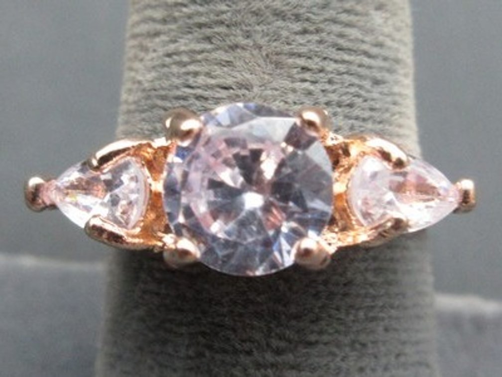 Unmarked rose-gold-colored ring with clear stones