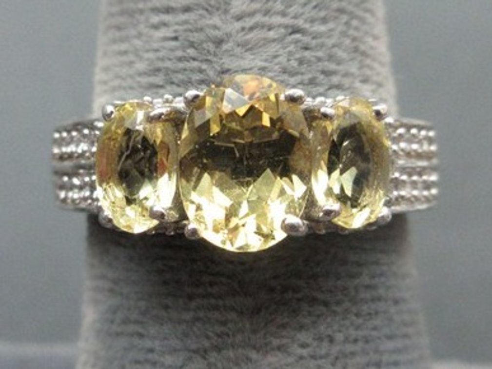 Marked .925 silver filigree ring with (3) light green stones