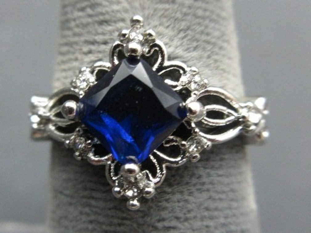 Unmarked silver-tone ring with blue square-cut tone