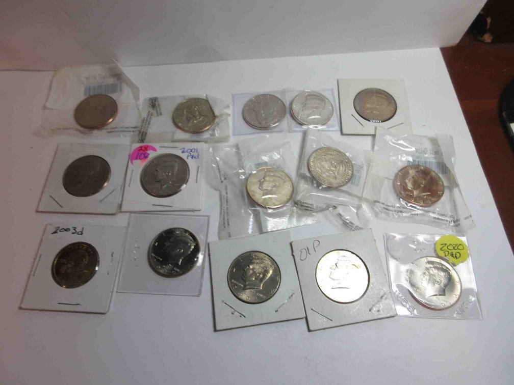 (14) Kennedy half dollars and (1) Sacajawea dollar