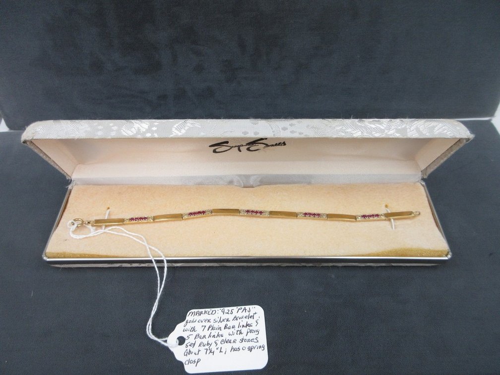 Marked .925 PAJ gold over silver bar link bracelet with ruby and clear stones