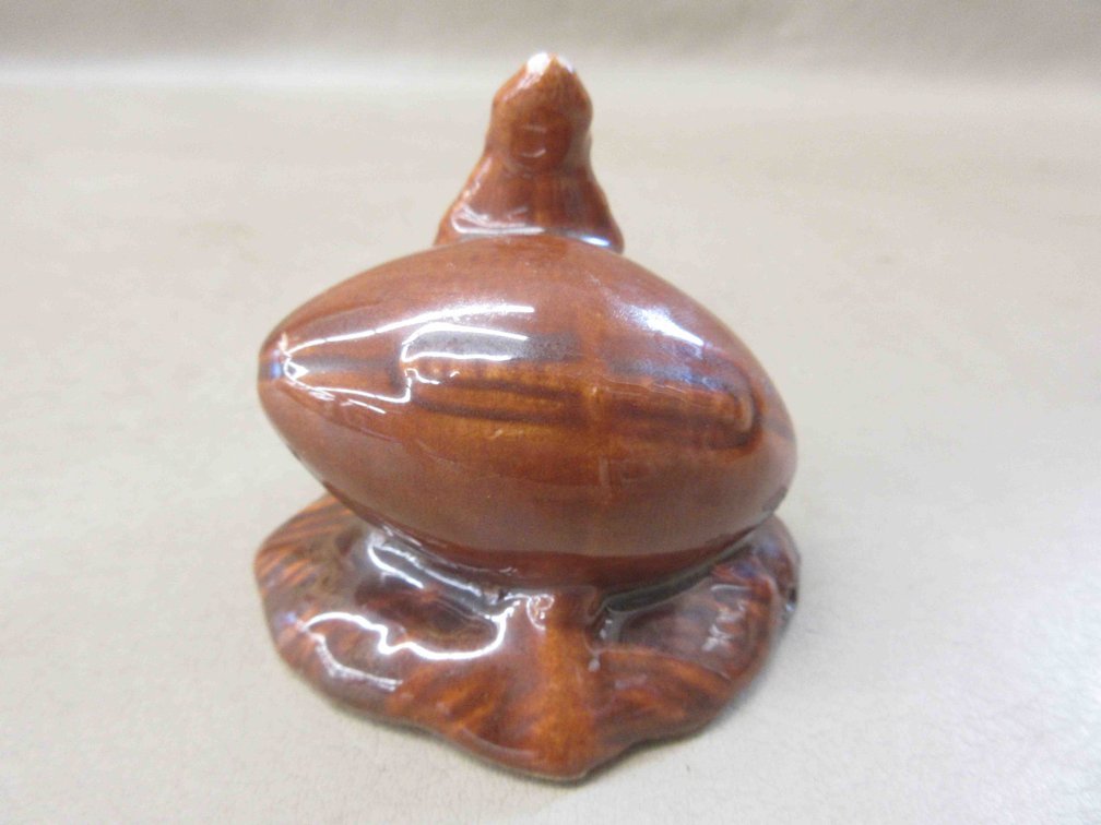 Unmarked Pottery Badger and football figurine
