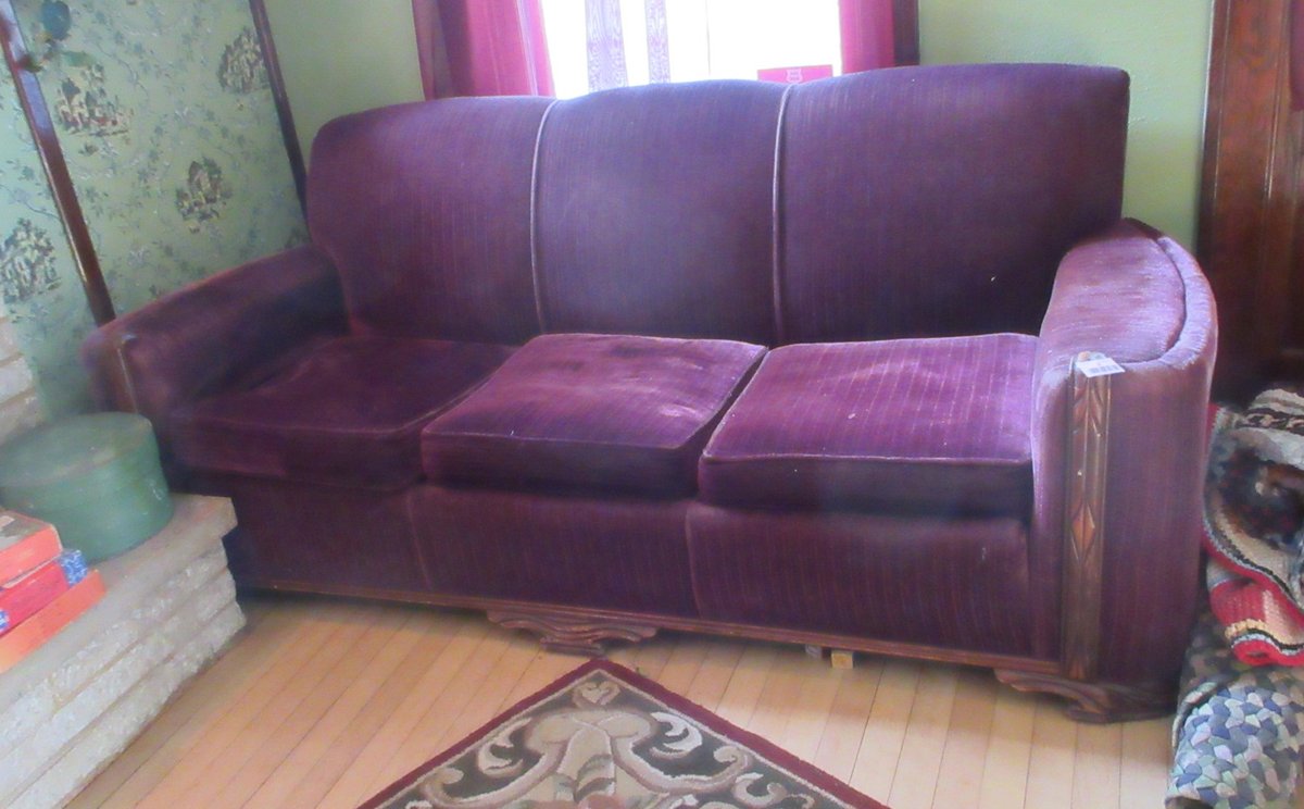 Antique upholstered sofa with wood detail