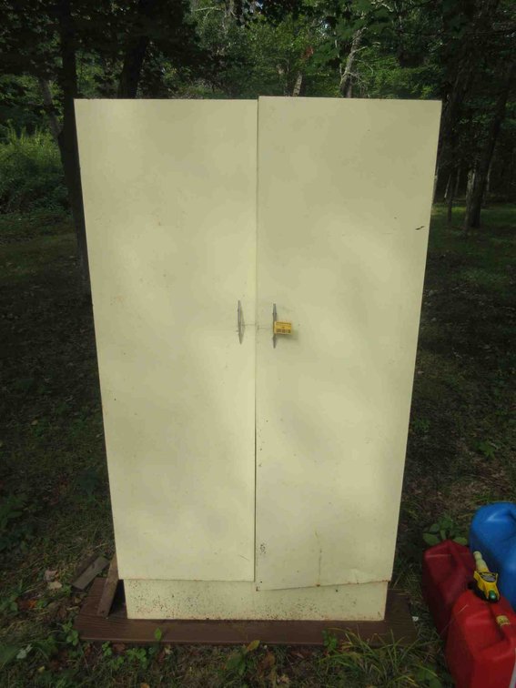 Metal cabinet with contents of yard tools
