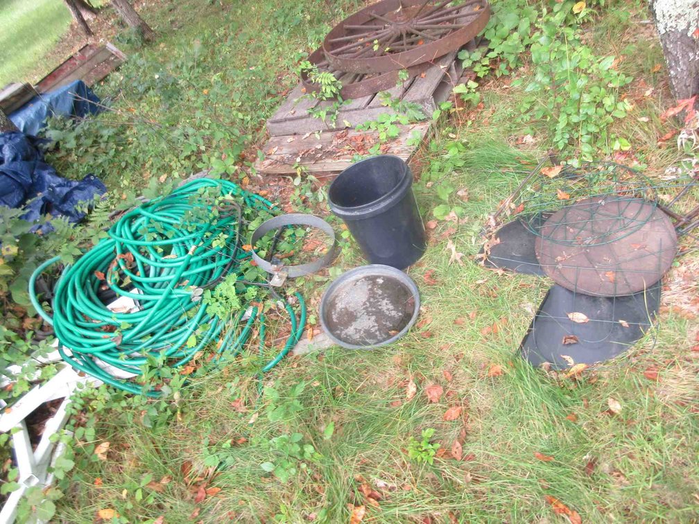 Group of garden hoses & metal garden items