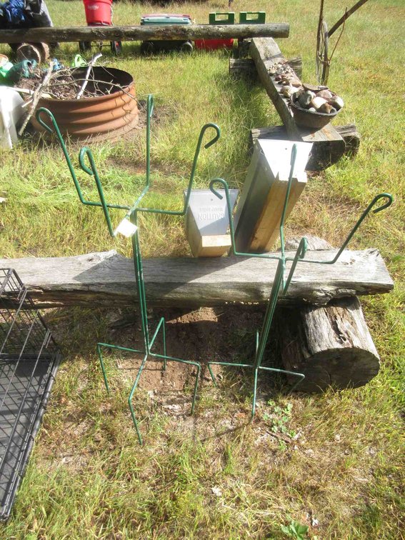 Pair of metal saw horses and (2) plant stands