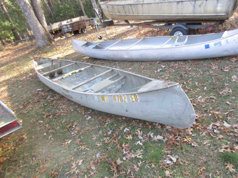 Aluminum canoe with paddles