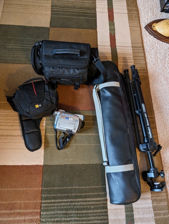 Tripod with Bag and an Empty Camera Bag and handheld Canon Digital Video Camcorder model ZR65