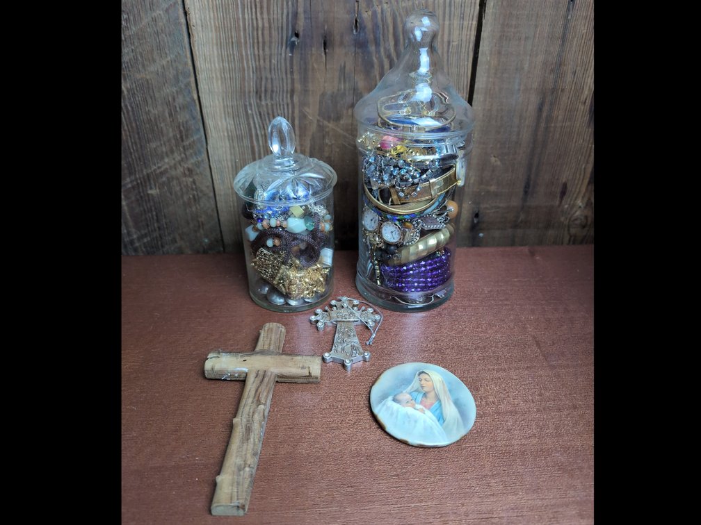 2 jars of Mystery Jewelry, 2 crosses, and a magnet 