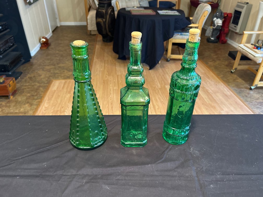 Three Decorative Emerald Green Embossed Glass Bottles with Cork Stoppers