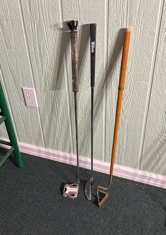 Three Vintage Golf Putters with Distinct Styles and Grips