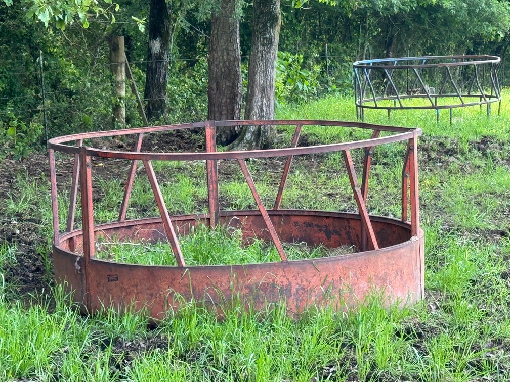 2 Hay Rings in Pasture by Equipment