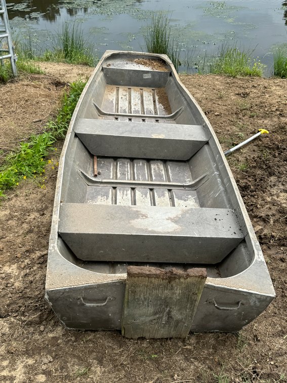 Flat Bottom Boat beside Windmill