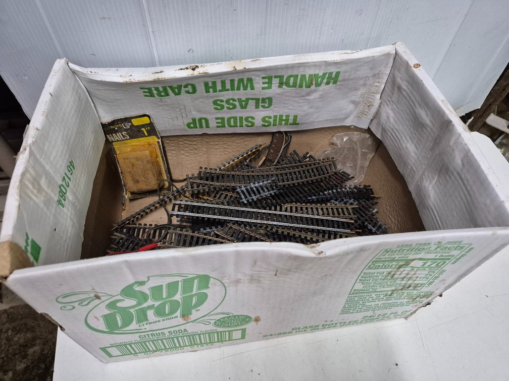 Box of model train track +