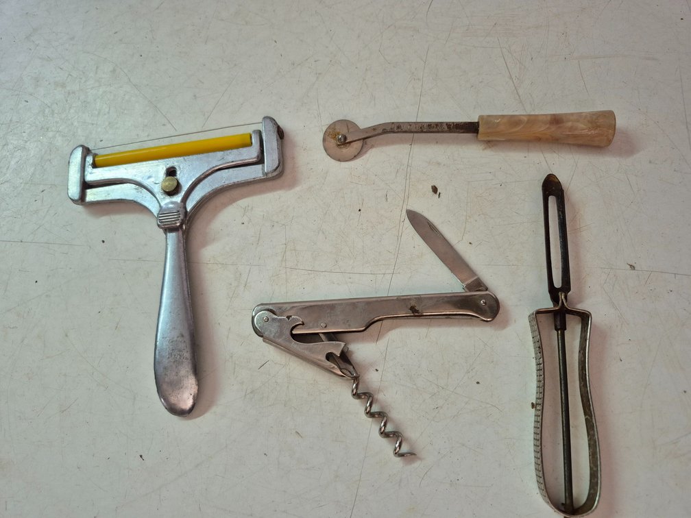 Tracing wheel with bakelite handle, cheese slicer, wine opener, peeler