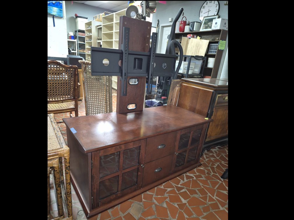 Wood entertainment center with tv mount and lots of storage underneath