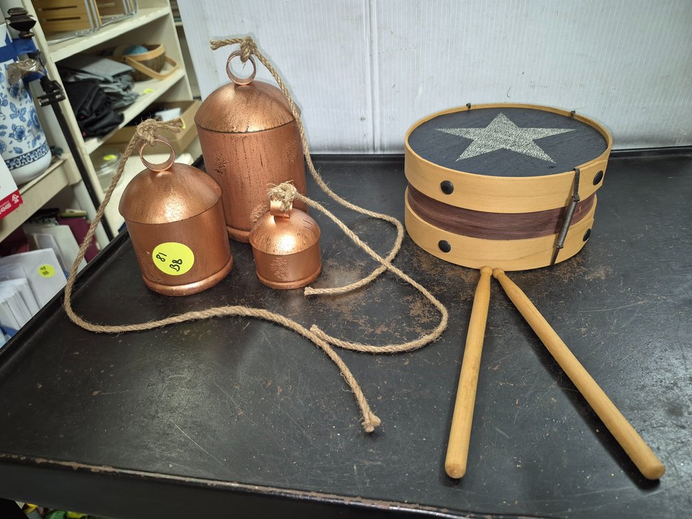 Hanging tin bells, wood drum decor with sticks