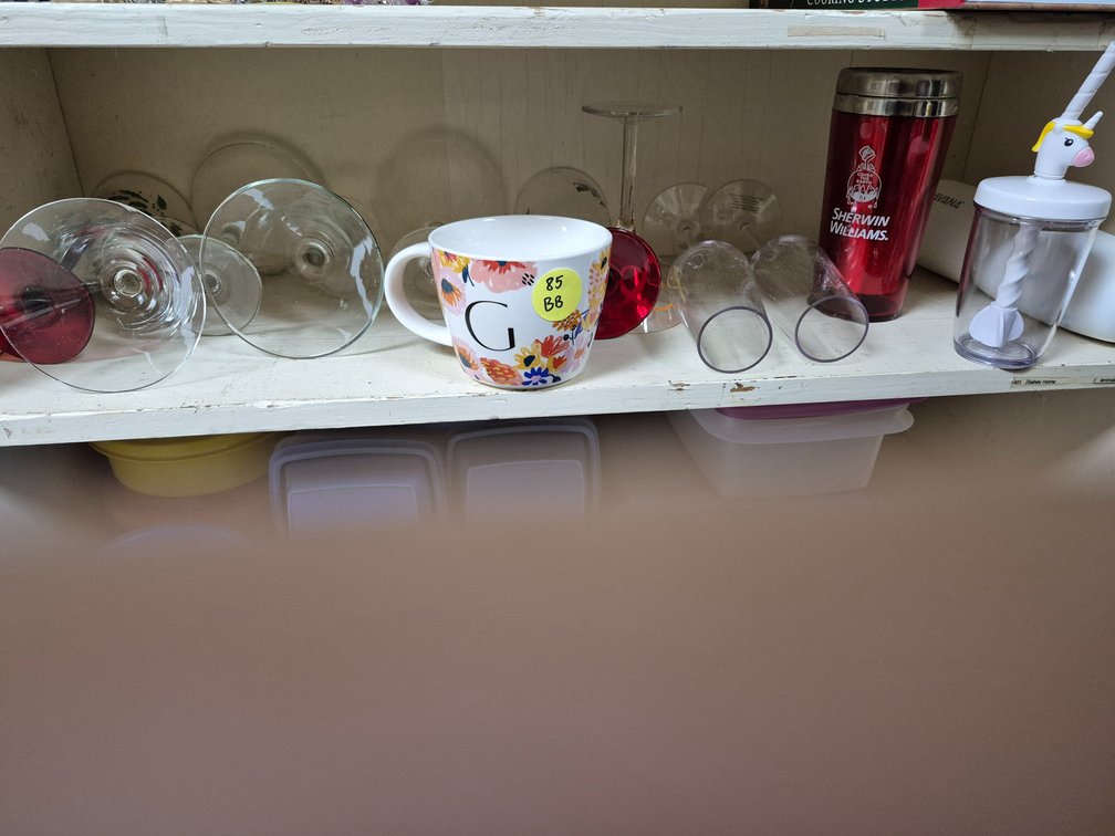 Shelf of stemware, mug, travel cups