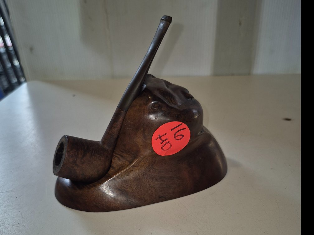 Tobacco pipe with hand carved natural wood stand.