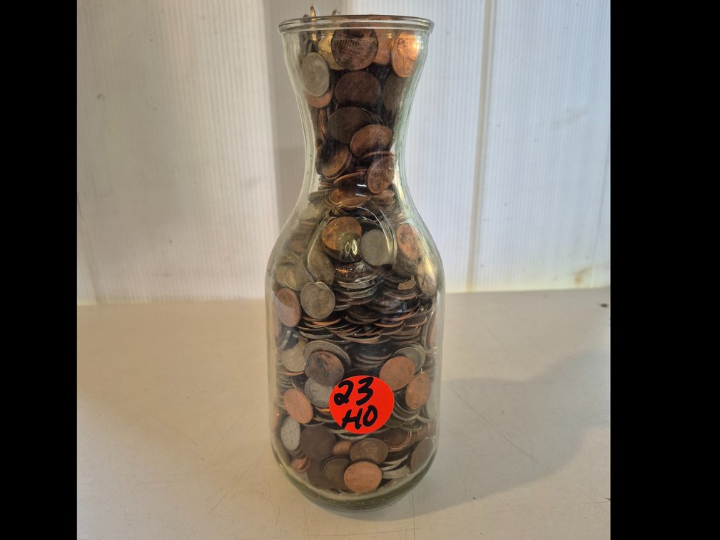 Wine carafe full of unsorted change