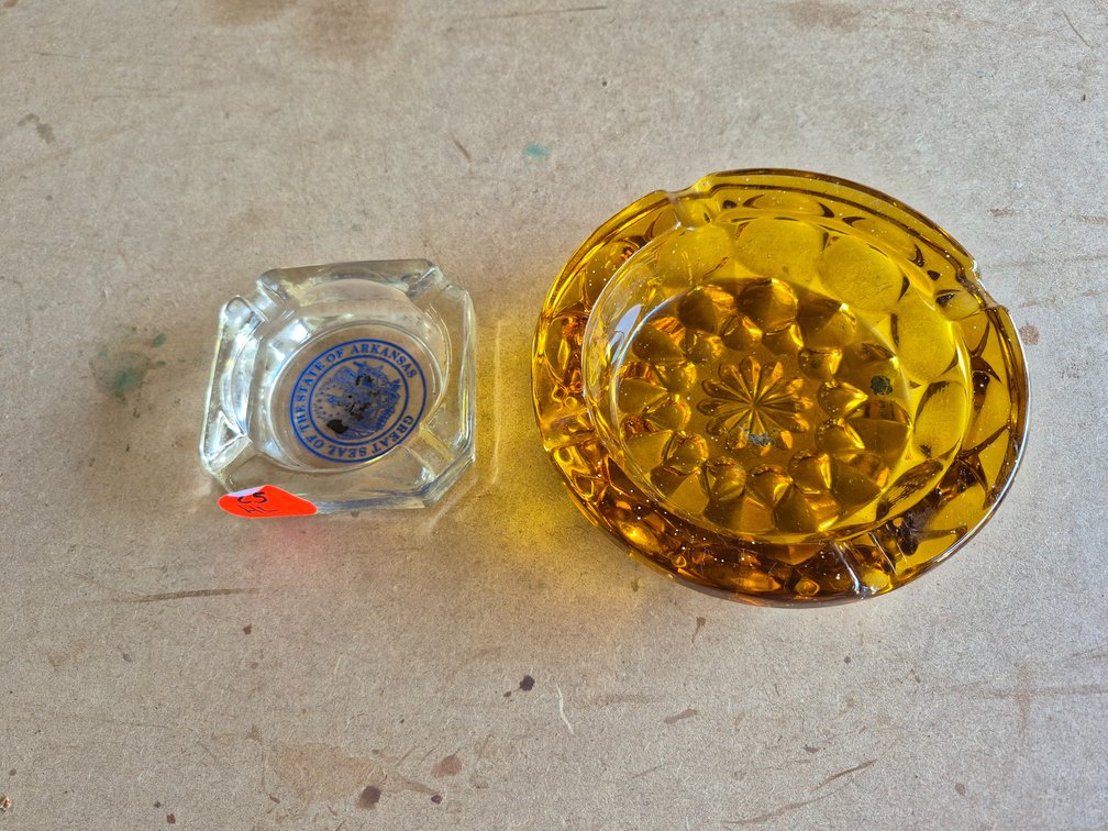 Amber glass and Arkansas ashtrays