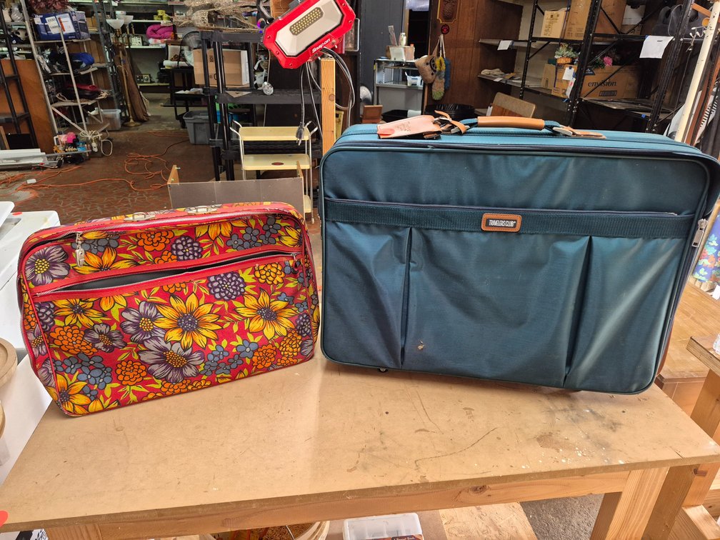 Traveler's Club softside rolling suitcase and a canvas bag