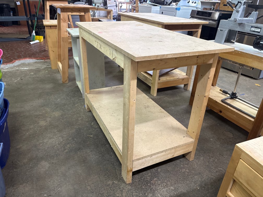 Wood shop table with pressed board shelves