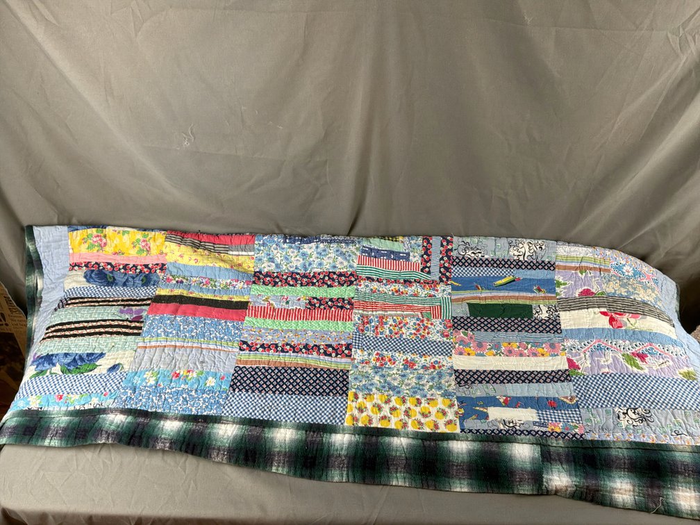Multicolored Strip Patchwork Quilt with Plaid Backing