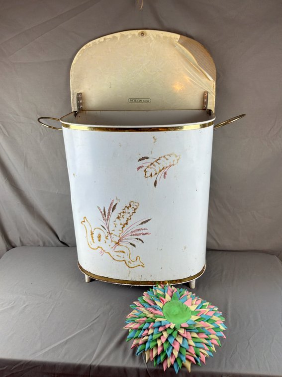 White Metal Laundry Hamper and Folded Fabric Rosette