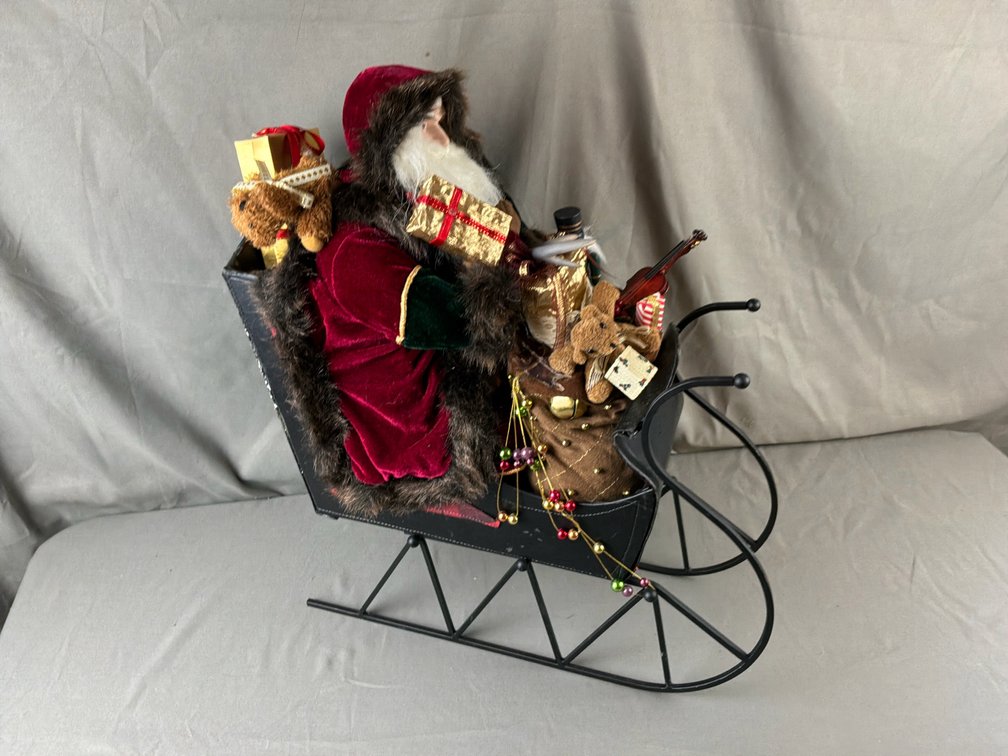 Santa Claus Figure in Black Metal Sleigh
