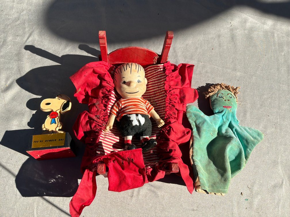 Doll in Wooden Bed, Snoopy Trophy, and Corduroy Hand Puppet