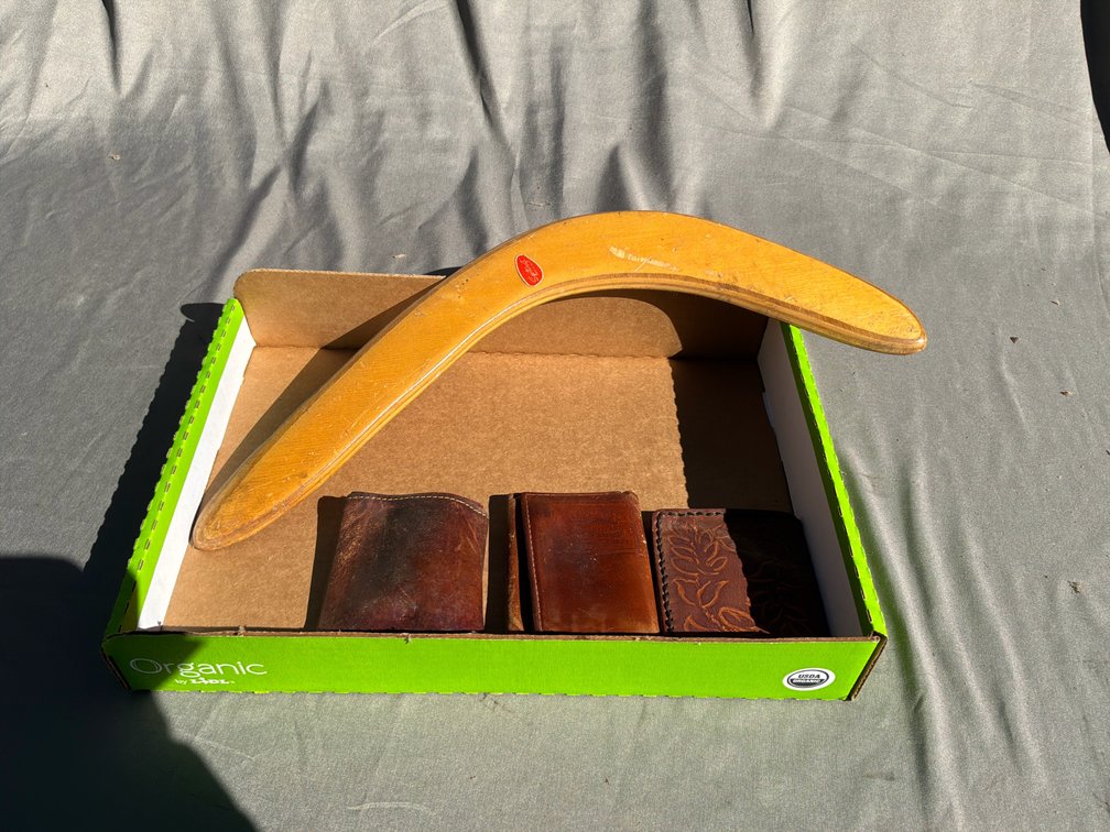 Bent Wood Boomerang and Brown Leather Wallets