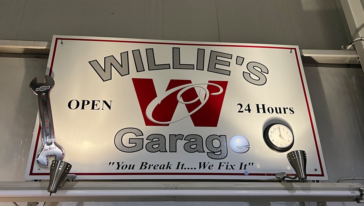Willie’s Garage advertising sign with mounted lights