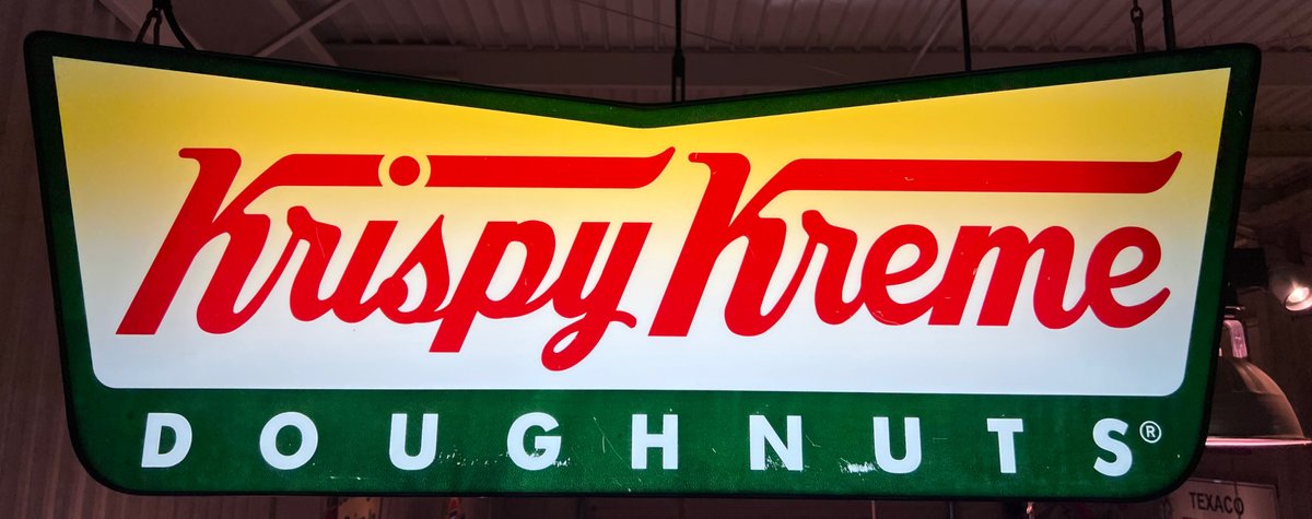 Krispy Kreme Doughnuts illuminated hanging sign.