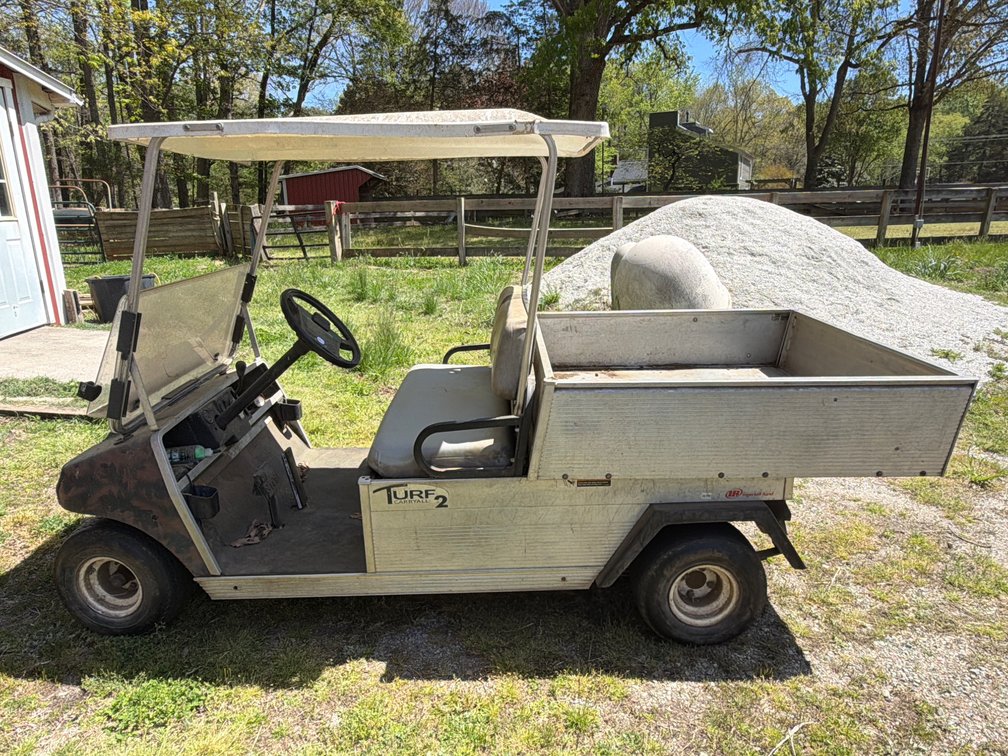Club Car Carryall Turf 2 utility vehicle features an aluminum frame and hydraulic dump bed