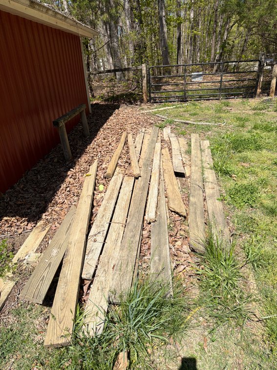 (14) - 16’ boards, hay bale, and an assorted lot wood pile