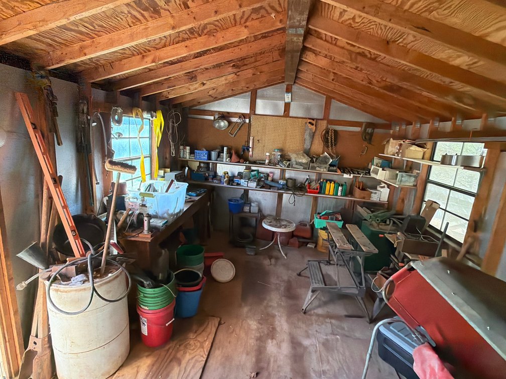 Large shed lot with landscaping tools, gas cans, workbench, etc