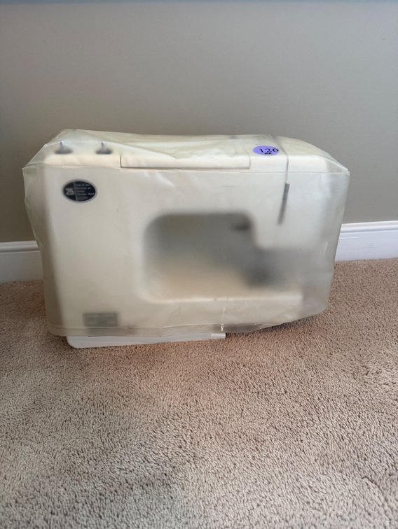 vintage white Kenmore sewing machine with cover
