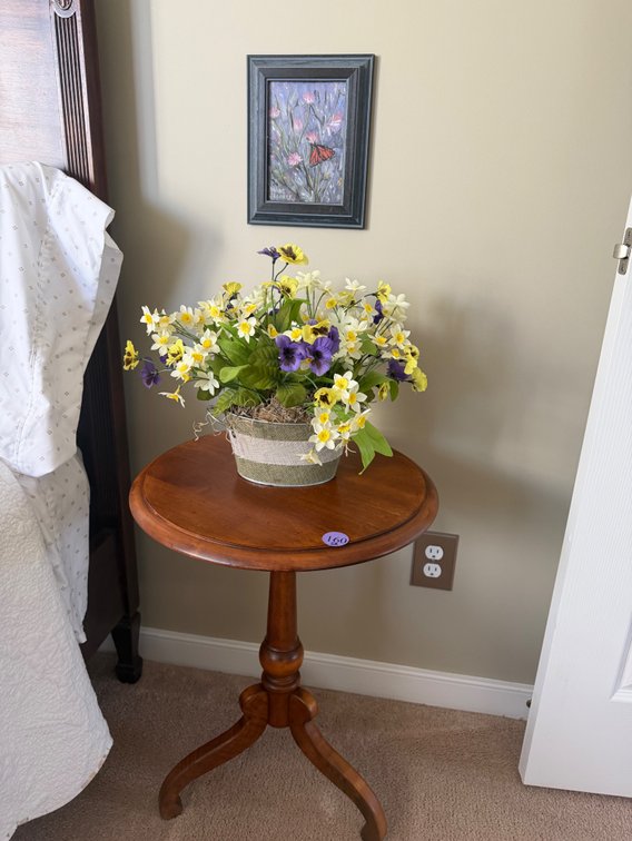 Accent table, floral arrangement, and a butterfly painting