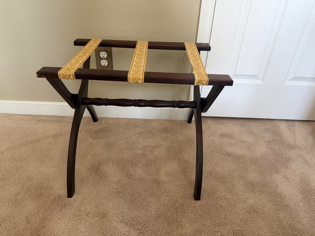 a folding wood luggage rack with curved legs