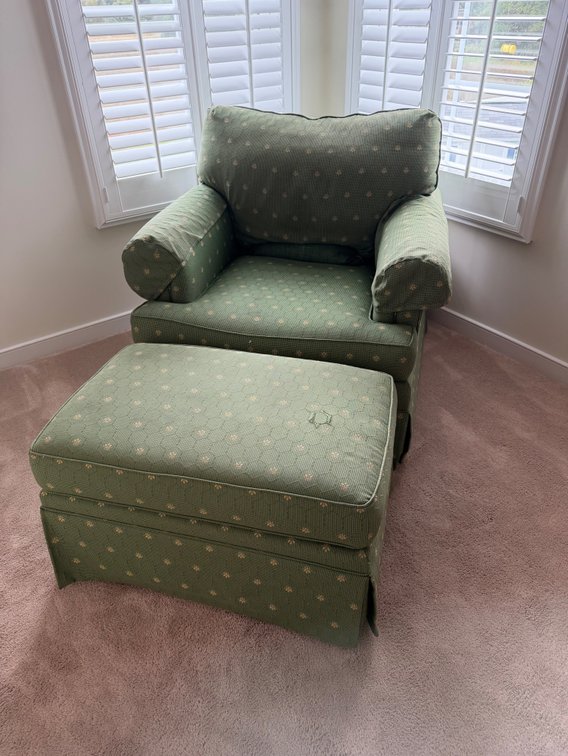 traditional green patterned upholstered accent armchair with a matching tufted ottoman and a tailored skirt