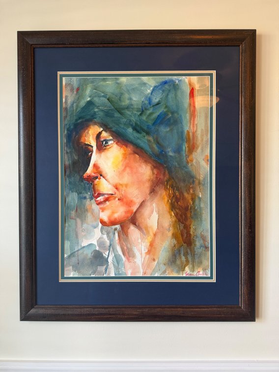 A framed watercolor portrait