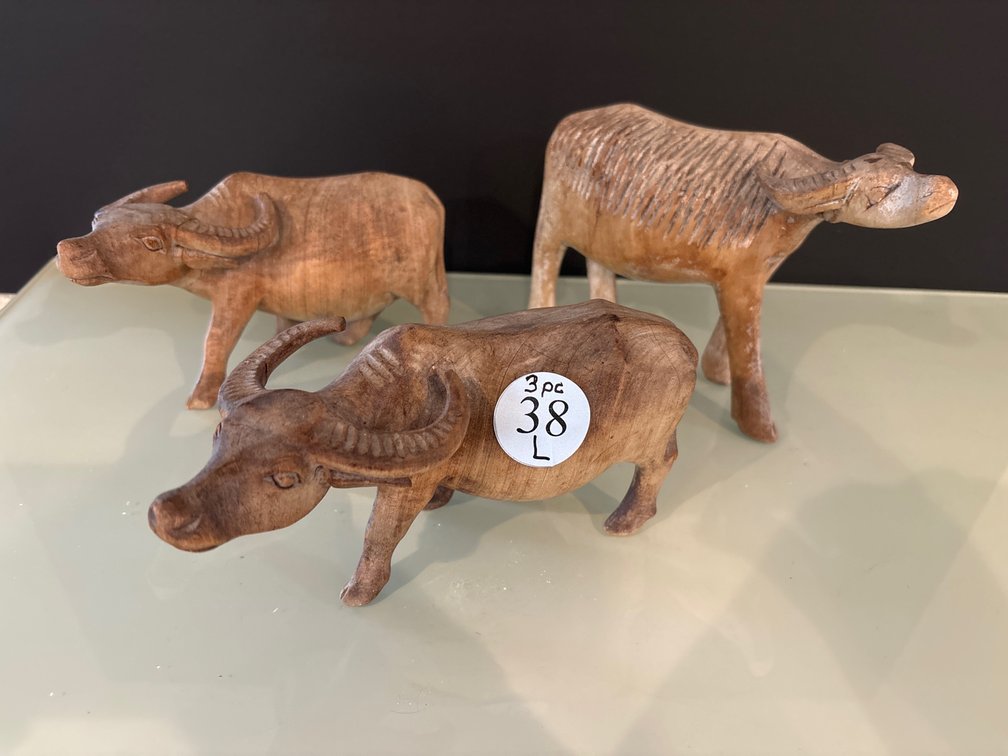 3 carved wooden water buffalo; tallest is 5”