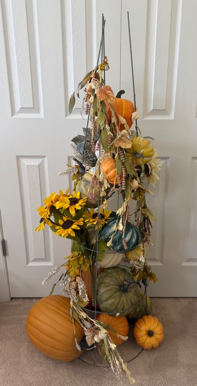 Fall pumpkin obelisk tower with artificial pumpkins, sunflowers, and basket with books included