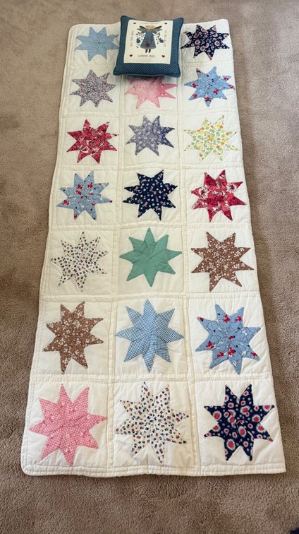 handmade runner quilt with small decorative pillow
