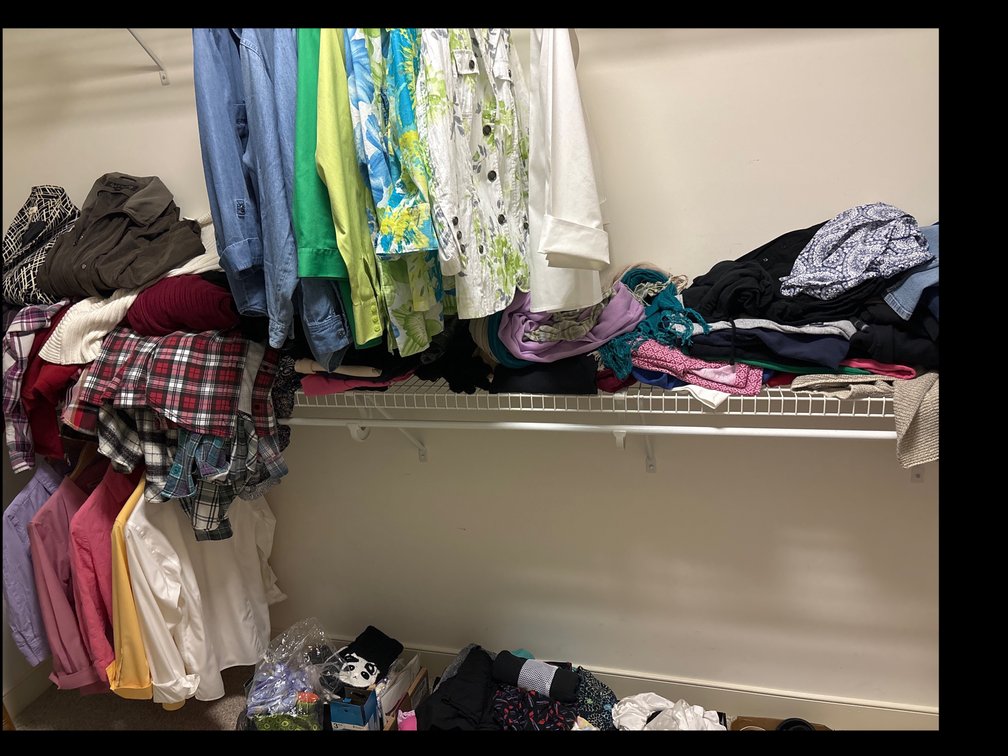 Contents of closet in primary bedroom; women’s clothing