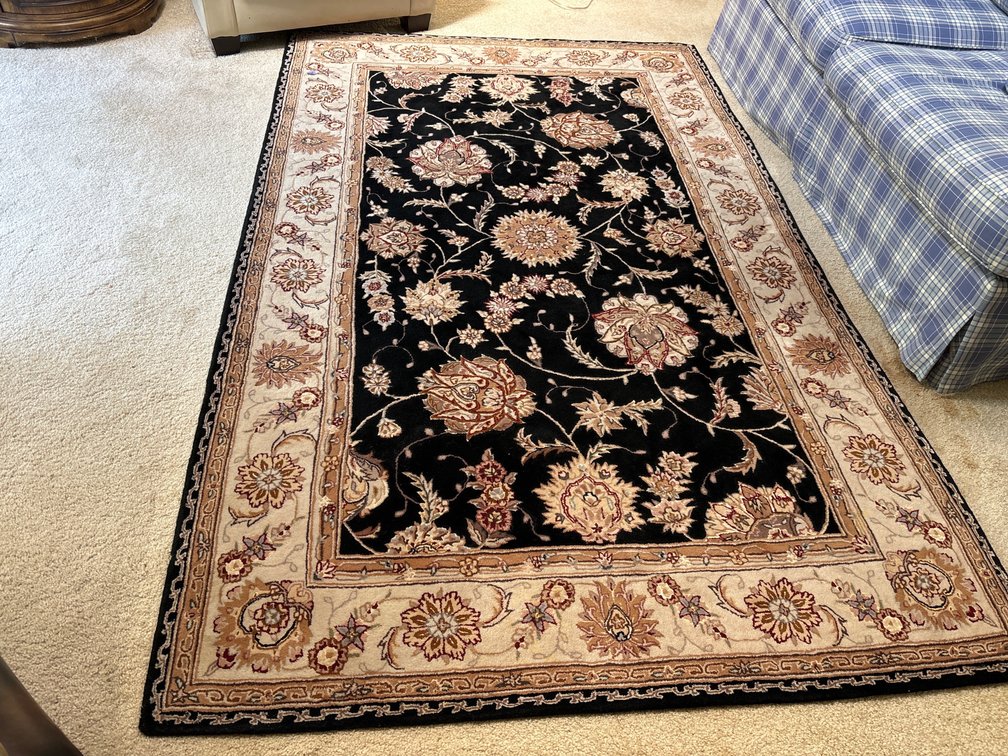 Patterned rug, black and tan; approx 5’ x 8’