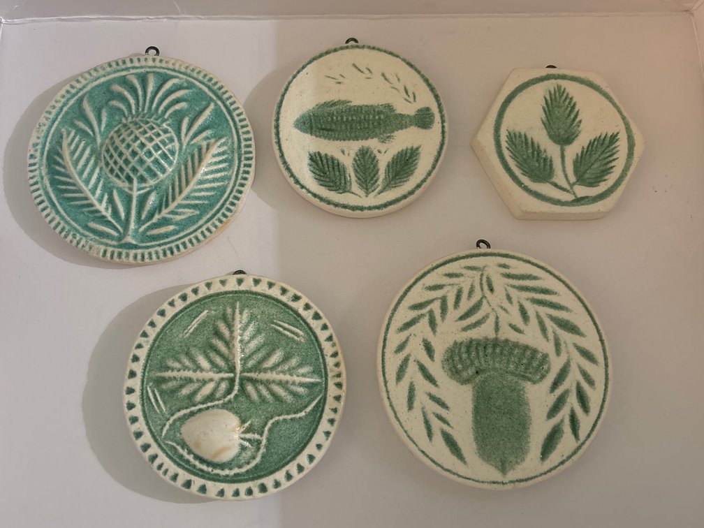 5 plaster casts of antique butter molds; painted, w/ hanger